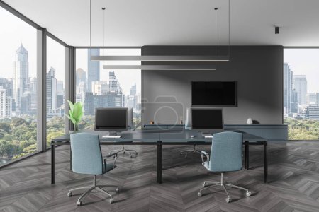 Photo for Modern office interior with pc computers and desk, sideboard and tv display. Minimalist coworking space with panoramic window on Bangkok skyscrapers. 3D rendering - Royalty Free Image