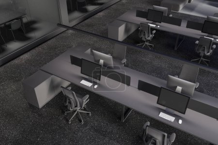 Photo for Top view of dark office interior with coworking corner, pc computers on shared desk and chairs in row. Glass minimalist meeting boxes with table and chairs. 3D rendering - Royalty Free Image