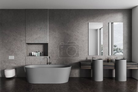 Téléchargez les photos : Intérieur de salle de bain élégante avec murs en pierre sombre, sol en béton, confortable lavabo double gris avec deux miroirs verticaux, baignoire confortable et toilettes. Rendu 3d - en image libre de droit