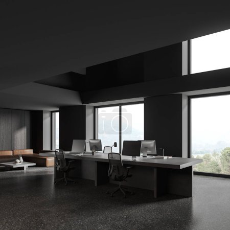 Téléchargez les photos : Corner view of dark business interior with armchairs and pc monitors, shared table and sofa near panoramic window on countryside. Modern workspace with minimalist design. 3D rendering - en image libre de droit