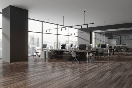 Photo for Dark office interior with coworking corner, side view pc computers on desk in row. Glass meeting room with board and armchairs, panoramic window on Kuala Lumpur skyscrapers. 3D rendering - Royalty Free Image