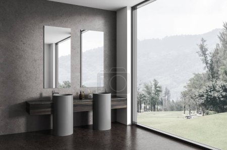 Foto de Cuarto de baño interior oscuro con doble lavabo y espejos, ventana panorámica en el campo. Esquina de baño del hotel con accesorios minimalistas y suelo de hormigón. Renderizado 3D - Imagen libre de derechos