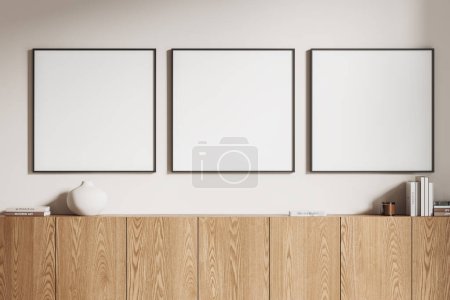 Photo for Stylish home living room interior with wooden sideboard, minimalist art decoration and books. Three mock up square canvas posters in row on white wall. 3D rendering - Royalty Free Image