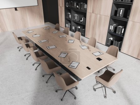 Foto de Vista superior del elegante interior de la sala de reuniones de la oficina con paredes de madera, piso de hormigón, mesa de conferencias larga con sillas y librerías con carpetas. renderizado 3d - Imagen libre de derechos