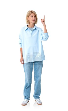 Photo for Beautiful blonde woman in long polo and denim jeans, finger point up. Pensive person full length isolated over white background. Concept of business startup and idea - Royalty Free Image