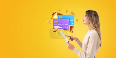 Photo for Side portrait of woman finger touch tablet, two mock up credit cards, falling coins and arrow on empty background. Concept of money transferring, bank account and client service - Royalty Free Image