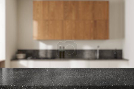 Téléchargez les photos : Table en granit de pierre sur fond flou de cuisine intérieure minimaliste, évier avec cuisinière et ustensiles de cuisine. Maquette de l'espace de copie pour l'affichage du produit. rendu 3D - en image libre de droit