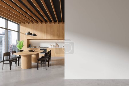 Téléchargez les photos : Intérieur de la cuisine moderne avec des murs en bois, sol en béton, placards et armoires en bois, table à manger et mur d'espace de copie blanche sur la droite. Rendu 3d - en image libre de droit