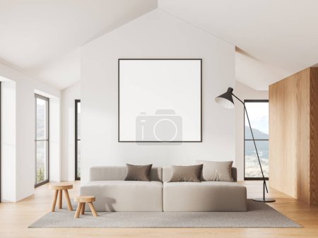 Foto de Acogedor interior de la sala de estar con sofá y alfombra en el suelo de madera. Zona de salón con ventana panorámica al campo. Simular cartel de lona cuadrada en la pared. Renderizado 3D - Imagen libre de derechos