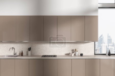 Téléchargez les photos : Élégant intérieur de cuisine moderne avec armoire et évier, cuisinière et ustensiles de cuisine. Armoire beige avec fenêtre panoramique sur les gratte-ciel de Bangkok. rendu 3D - en image libre de droit