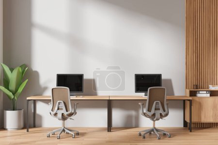 Photo for Cozy business interior with armchairs and pc computer on desk in row, hardwood floor. Modern office workplace and drawer, mock up empty copy space wall. 3D rendering - Royalty Free Image