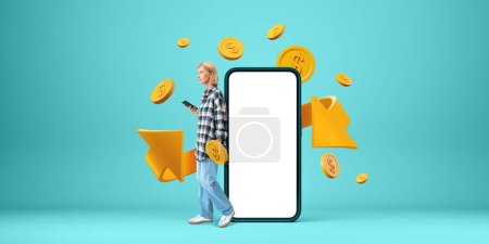 Photo for Blonde woman standing near mockup smartphone display, gold arrow with coins falling on green background. Concept of refund and digital payment, cashback and money return - Royalty Free Image
