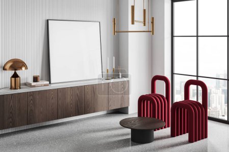 Foto de Esquina de la moderna sala de estar con paredes blancas, suelo de hormigón, cómoda de madera con la maqueta cuadrada encima del cartel de pie en él y dos sillas rojas. renderizado 3d - Imagen libre de derechos