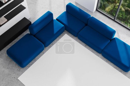 Photo for Top view of stylish home living room interior with sofa and carpet, minimalist shelf with books on grey concrete floor. Panoramic window on tropics. 3D rendering - Royalty Free Image