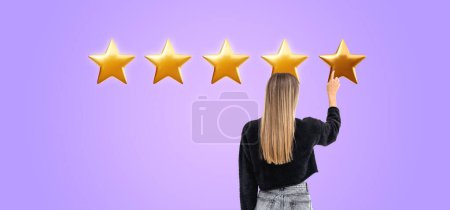 Photo for Rear view of woman finger touch or click on five star rating, purple background. Concept of positive review, evaluation, highly recommended and customer satisfied - Royalty Free Image