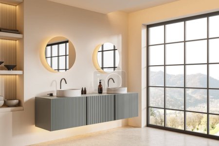 Photo for Corner view of home bathroom interior with double sink, shelf and vanity with accessories. Two round mirrors on beige wall. Panoramic window on countryside. 3D rendering - Royalty Free Image