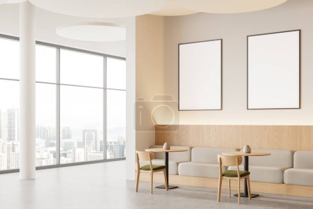 Foto de Esquina de restaurante moderno con paredes blancas y de madera, suelo de hormigón, cómodas mesas redondas con sillas y sofás grises y carteles verticales simulados. renderizado 3d - Imagen libre de derechos