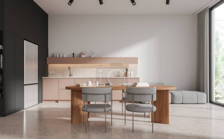 Foto de Interior de la cocina moderna con bolas blancas y negras, suelo de hormigón, armarios beige y mesa de comedor larga con sillas grises. renderizado 3d - Imagen libre de derechos