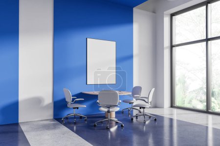 Photo for Corner of modern office meeting room with white and blue walls, round conference table with chairs and vertical mock up poster. 3d rendering - Royalty Free Image