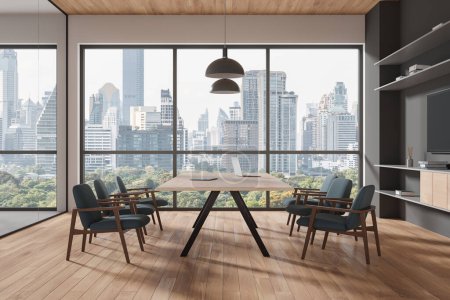 Photo for Wooden office interior with board and armchairs, laptop and tv console with decoration. Business conference room with panoramic window on Bangkok skyscrapers. 3D rendering - Royalty Free Image