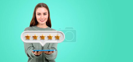 Photo for Beautiful woman offer digital tablet, five stars bubble on empty copy space green background. Concept of giving positive review online, client service and feedback request - Royalty Free Image