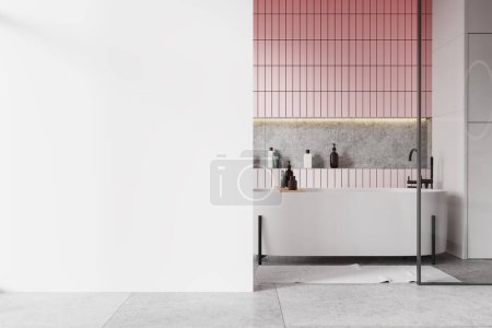Interior of modern bathroom with pink tile and white walls, tiled floor, comfortable white bathtub and copy space wall on the left. 3d rendering