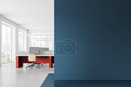 Photo for Interior of bright open space office with blue and white walls, concrete floor and red computer tables with yellow chairs. Copy space wall on the right. 3d rendering - Royalty Free Image