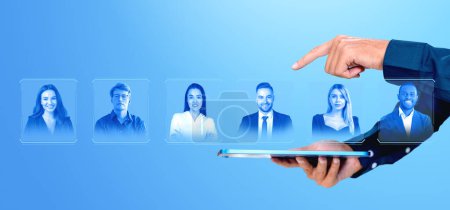 Photo for Man finger touch tablet choosing candidate, virtual screen with glowing contact icons with profile pictures, online headhunting. Concept of vacancy, recruitment and HR - Royalty Free Image