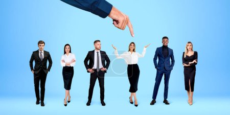 Photo for Hand of businesswoman HR manager choosing the right candidate from row of people standing over blue background. Concept of human resources and recruitment - Royalty Free Image