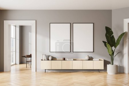 Photo for Interior of modern living room with gray walls, wooden floor, comfortable wooden dresser and two vertical mock up posters hanging above it. 3d rendering - Royalty Free Image
