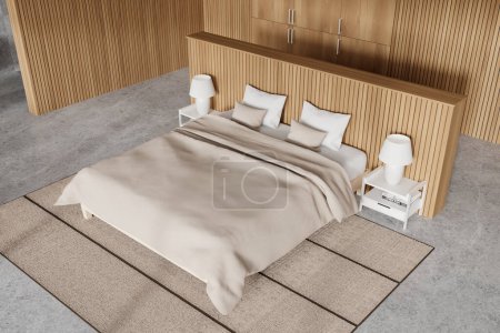 Photo for Top view of modern hotel bedroom interior with bed and nightstand, books and lamps. Sleep corner with wooden wardrobe and carpet on concrete floor. 3D rendering - Royalty Free Image