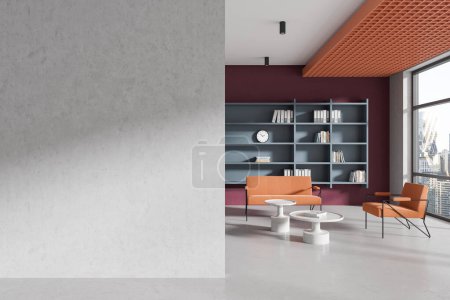 Photo for Interior of modern office waiting room with white and red walls, concrete floor, orange sofa and armchair standing near coffee tables and copy space wall on the left. 3d rendering - Royalty Free Image
