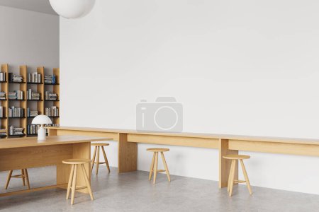Photo for Corner view of white stylish library interior wooden bookshelf with books, work desk with stool in row on concrete floor. Reading or learning space with mockup empty blank wall. 3D rendering - Royalty Free Image