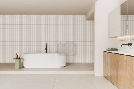 Foto de Interior minimalista del baño doméstico con bañera, lavabo y accesorios minimalistas en la mesa auxiliar y tocador. Espacio de baño en apartamento moderno con pared de baldosas y suelo de hormigón. Renderizado 3D - Imagen libre de derechos