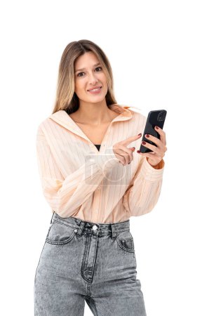 Photo for Happy young woman finger touch phone in hands, looking at the camera isolated over white background. Concept of online shopping, social media and internet communication - Royalty Free Image