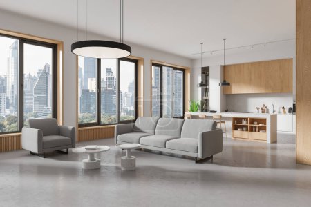 Photo for Corner view of flat studio interior with sofa and armchair, concrete floor. Cooking cabinet with bar island and stool, panoramic window on Bangkok skyscrapers. 3D rendering - Royalty Free Image