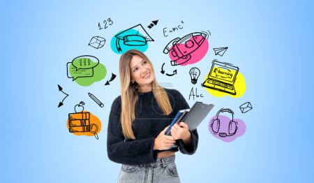 Photo for Dreaming woman student with notebook in hands, looking aside at colorful doodle drawing of educational icons, rocket take off and light bulb. Concept of e-learning and online studies - Royalty Free Image