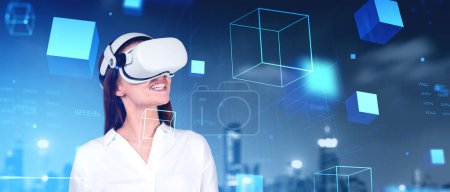 Young woman wearing VR headset experiencing virtual reality technology. Night city skyline online cyberspace journey. Metaverse and wearable devices. Cubes and code