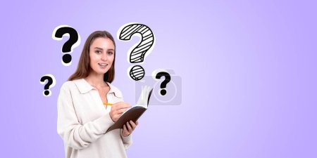 Photo for A woman holding a book with question marks around her on a purple background, symbolizing curiosity or inquiry - Royalty Free Image