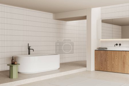 Foto de Vista de esquina del interior del baño en casa con bañera, lavabo y accesorios en tocador y mesa auxiliar. Espacio de baño en apartamento moderno con pared de baldosas y suelo de hormigón. Renderizado 3D - Imagen libre de derechos