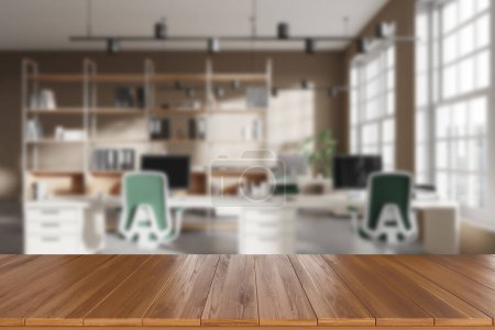 Photo for Wooden desk on foreground, background of blurred coworking interior with armchairs and pc computer, office loft with panoramic window. Mockup for product display. 3D rendering - Royalty Free Image