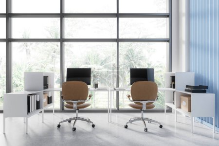 Photo for White and blue coworking interior with pc desktop on white tables in row, concrete floor. Cozy workplace with panoramic window on tropics view. 3D rendering - Royalty Free Image