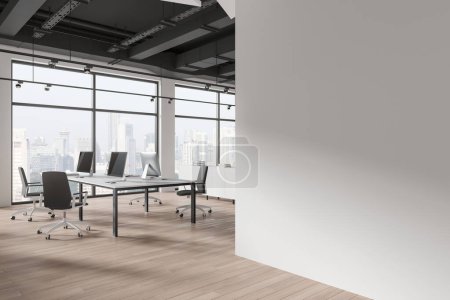 Photo for Modern office interior with desks, computers, chairs, large windows with a city view, and a blank wall, 3D Rendering. - Royalty Free Image