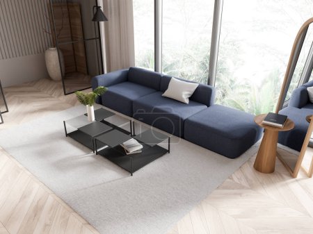 Téléchargez les photos : Salon intérieur moderne avec canapé bleu et table basse en verre sur un sol en bois, éclairé par la lumière naturelle, concept de la maison. Rendu 3D - en image libre de droit