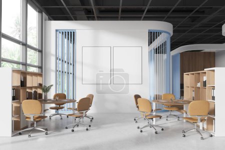 Photo for Stylish conference interior with armchairs and tables, concrete floor. Meeting area with stylish furniture, two mockup canvas posters in row. Panoramic window on tropics. 3D rendering - Royalty Free Image