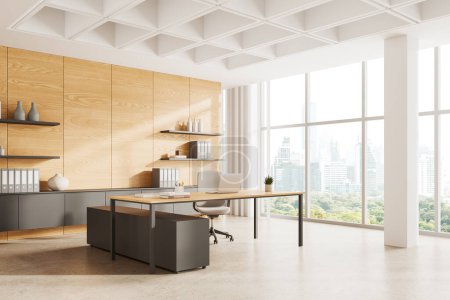 Photo for Corner view of ceo interior with laptop on desk, armchair on concrete floor. Consulting space and sideboard with shelves. Panoramic window on Bangkok skyscrapers. 3D rendering - Royalty Free Image