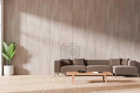 Foto de Interior de la sala de estar del hogar ligero con sofá marrón y mesa de centro, decoración minimalista y planta en piso de madera dura. Zona de salón con espacio para copiar pared de azulejos vacía. Renderizado 3D - Imagen libre de derechos