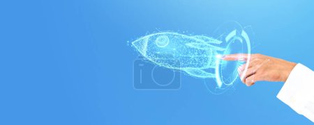 Photo for A hand touching a digital hologram of a rocket, symbolizing startup concept on a blue background - Royalty Free Image