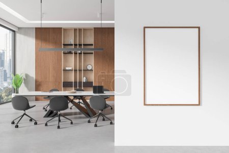 Photo for Conference interior with chairs and meeting table, light concrete floor. Negotiation space with shelf and decoration, panoramic window on skyscrapers. Mockup blank canvas poster. 3D rendering - Royalty Free Image