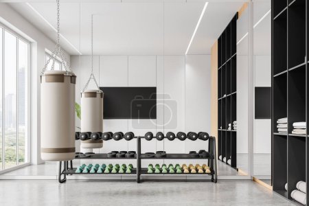 Home gym class interior with dumbbell rack, punching bag and shelf with towels and mat on concrete floor. Sport or fitness space with tv screen and panoramic window on skyscrapers. 3D rendering